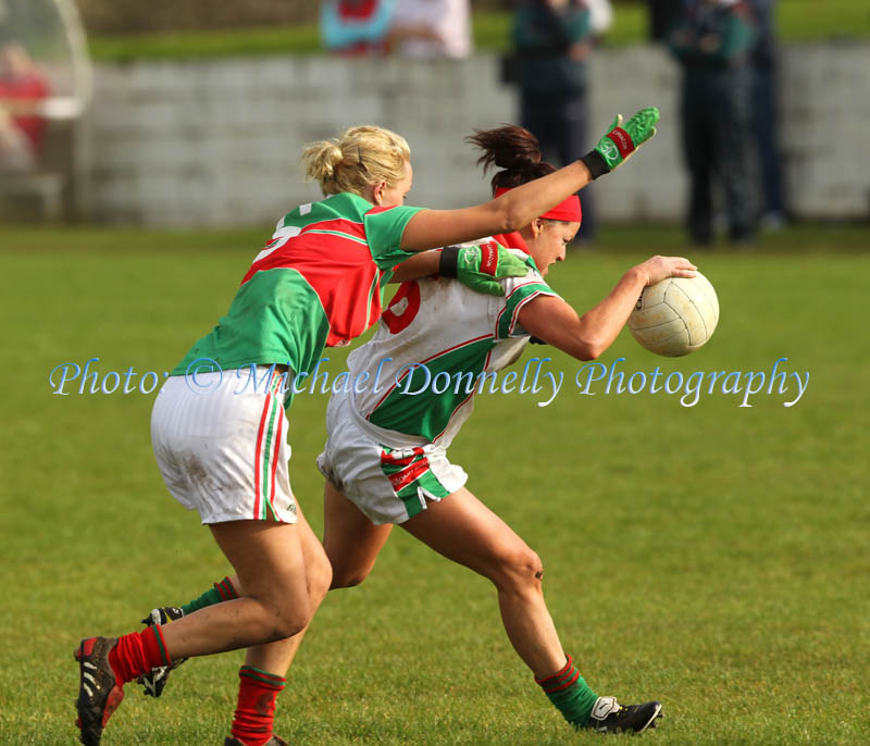 Carnacon's Aoife Loftus tries to stop the advance of Claire Grehan, of St Bridgids Kiltoom, in the Tesco Connacht Ladies Gaelic Football  Senior Club Championship final in Canon Gibbons Park Claremorris. Photo: © Michael Donnelly Photography