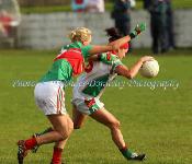 Carnacon's Aoife Loftus tries to stop the advance of Claire Grehan, of St Bridgids Kiltoom, in the Tesco Connacht Ladies Gaelic Football  Senior Club Championship final in Canon Gibbons Park Claremorris. Photo: © Michael Donnelly Photography