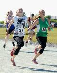 Swinford's Aisling Forkan  pips Westport on the line in the girls U-14 Relay at the Mayo finals of the HSE Community Games in Claremorris Track.Photo: © Michael Donnelly