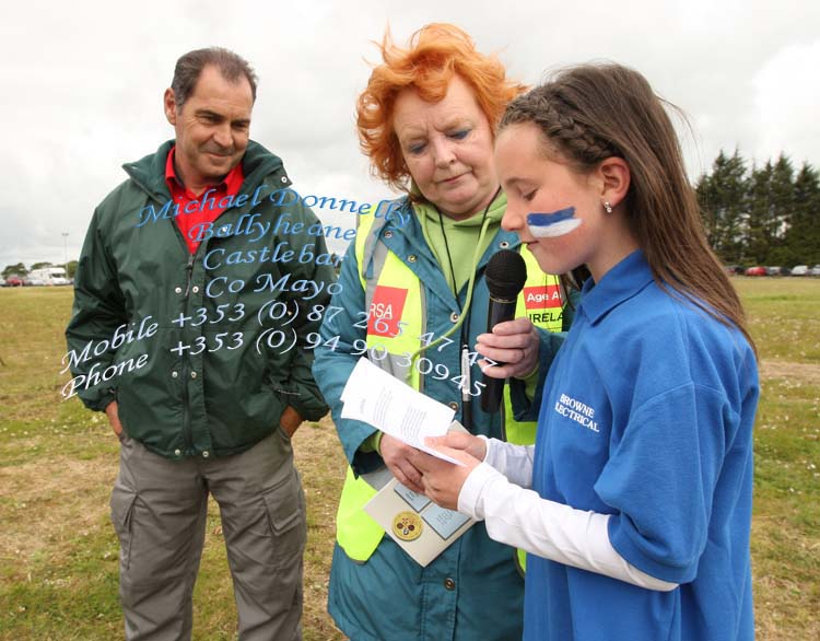 Aoife Bermingham Claremorris recites the Pledge in Irish at Mayo Community Games Athletic Finals at Claremorris Track, included in photo are Tommy Hereran Mayo Community Games Chairman and Mary McGreal Secretary and P. A on the Day. Photo:Michael Donnelly