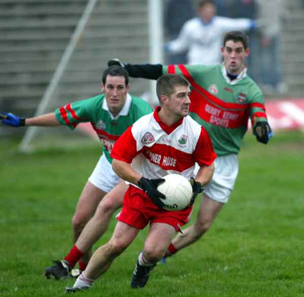 Stephen Hunt Aughamore is closely watched by Ballina Stephenites defenders in the Breaffy House and Spa  County Junior  Football Championship Final in McHale Park Castlebar. Photo: Michael Donnelly