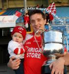 John Feeney captain Ballintubber pictured with hs son Chriastopher and the Moclair Cup after defeating  Castlebar Mitchels in the TF  Royal Hotel and Theatre Mayo Senior Football Championship final  in McHale Park