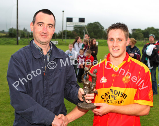 Daire Conway Castlebar  Mitchels is presented with the Man of the Match award in the Ulster Bank U-21A County Football Championship final in Fr O'Hara Park Charlestown by Michael Boland, Ulster Bank Ballina, after defeating Crossmolina Deel Rovers. Photo:  Michael Donnelly