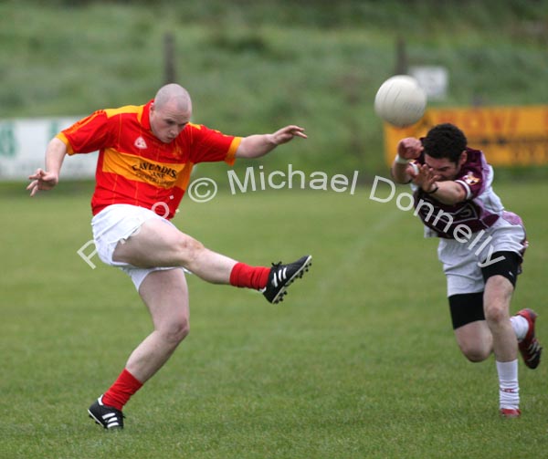 Enda Murphy sets  up an attack for Castlebar Mitchels, despite the attention of Crossmolina's Mark Leonard in the Ulster Bank U-21A County Football Championship final in Fr O'Hara Park Charlestown. Photo:  Michael Donnelly