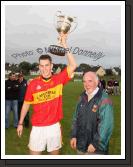 Barry Moran, captain Castlebar Mitchels U-21 team raises the Cup after it was  presented  by Paddy McNicholas, Vice Chairman Mayo GAA Board, in the Ulster Bank U-21A County Football Championship final in Fr O'Hara Park Charlestown after defeating Crossmolina Deel Rovers. Photo:  Michael Donnelly