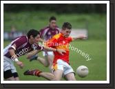 Cillian Gavin pulls the trigger despite the attention of Crossmolina's Mark Leonard in the Ulster Bank U-21A County Football Championship final in Fr O'Hara Park Charlestown. Photo:  Michael Donnelly