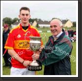 Barry Moran, captain Castlebar Mitchels U-21 team is presented with the Cup by Paddy McNicholas, Vice Chairman Mayo GAA Board, in the Ulster Bank U-21A County Football Championship final in Fr O'Hara Park Charlestown after defeating Crossmolina Deel Rovers. Photo:  Michael Donnelly