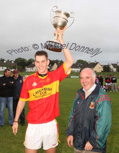 Barry Moran, captain Castlebar Mitchels U-21 team raises the Cup after it was  presented  by Paddy McNicholas, Vice Chairman Mayo GAA Board, in the Ulster Bank U-21A County Football Championship final in Fr O'Hara Park Charlestown after defeating Crossmolina Deel Rovers. Photo:  Michael Donnelly