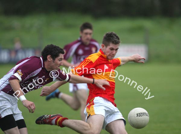 Cillian Gavin pulls the trigger despite the attention of Crossmolina's Mark Leonard in the Ulster Bank U-21A County Football Championship final in Fr O'Hara Park Charlestown. Photo:  Michael Donnelly