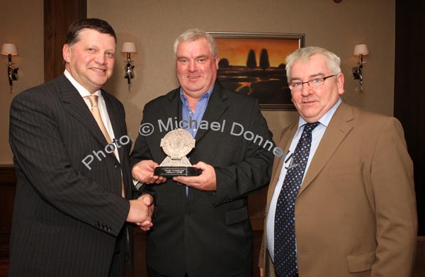 John O'Mahony presents an "Outstanding Service" award to Joe Regan at the Kilmovee Shamrocks Football Club annual Dinner in The Abbeyfield Hotel,  Ballaghaderreen, included in photo is John Caulfield, Kilmovee Shamrocks Club vice-chairman.Photo:  Michael Donnelly