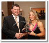 John O'Mahony makes a presentation to Emer Tansey in recognition of her participation in the Underdogs team 2008 at the Kilmovee Shamrocks Ladies Gaelic Football Club annual Dinner in The Abbeyfield Hotel, Ballaghaderreen. Photo:  Michael Donnelly