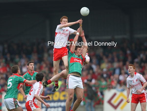 Noel McKenna (Tyrone) soaring high to break the ball against Mayo's Aiden O'Shea   in the ESB All Ireland Minor Football Final replay in Pearse Park, Longford.Photo:  Michael Donnelly