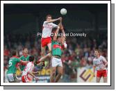 Noel McKenna (Tyrone) soaring high to break the ball against Mayo's Aiden O'Shea   in the ESB All Ireland Minor Football Final replay in Pearse Park, Longford.Photo:  Michael Donnelly