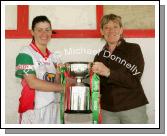 Christina  Heffernan is presented with the CBE Cup by Mary Quinn, President Ladies GAA Connacht Council after Mayo defeated Galway in the Connacht Ladies Football TG4 Senior Championship final in Tuam. Photo:  Michael Donnelly