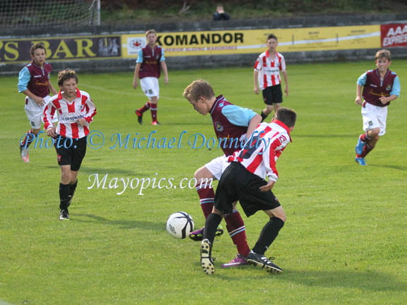   A Scully of West Ham and  J Rowe of Exeter City try to retain the ball at Celtic Park Castlebar in Mayo International Cup. Photo: © Michael Donnelly Photography