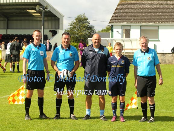 Anthony Scully captain U-13s and manager Mark Phillips of West Ham  pictured with match officials in the West Ham v Watford FC  game at Ballyglass in Mayo International Cup. Photo: © Michael Donnelly Photography