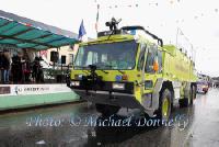 The Knock Airport "Fire and Rescue Service"vehicle dwarfed all of the other "Floats" as it passes the Reviewing stand with Johnny Kirrane on the Microphone at the Claremorris St Patricks Day Parade. Photo: © Michael Donnelly
