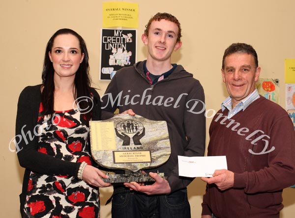 Keelan McNamara, St Colman's College, Claremorris, the Overall winner of the St Colman's (Claremorris) Credit Union Poster Competition 2009 is presented with the Gerry Rynne Memorial Trophy by Gerry's grandaughter Laura Hanley,  while John Timothy, Claremorris Credit Union presents him with his prizemoney;In the background is Keelan's winning poster. Photo:  Michael Donnelly