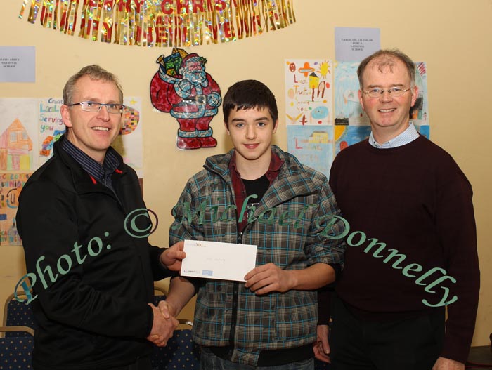 Joe Merrick, St Colmans College Claremorris, is presented with 1st  prize in the St Colmans College section of St Colman's (Claremorris) Credit Union Poster Competition 2010  by Tomas Ruane, Claremorris Credit Union, in the Dalton Inn, Claremorris. Included in photo on right  is Jimmy Finn, Principal St Colmans College. Photo: © Michael Donnelly