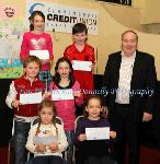 Winners of the Gaelscoil Uileog De Burca NS section of the Claremorris Credit Union Poster competition 2011 front from left Category A: Ruby Phillips, 1st;  Niamh Flanagan, 2nd and  Briain O Breaslain, (missing) was  3rd;  Middle row Category B: Edward O Cabraigh, 1st;  Sorcha Ni Threinfhir (missing) was, 2nd; and Muirgheal Ottowell, 3rd; At back category C: Orlagh Henry, 1st; Evan McDonagh, 2nd,  Matthew Finn (missing), 3rd, and Brendan Mellett Claremorris Credit Union. Photo: © Michael Donnelly Photography
