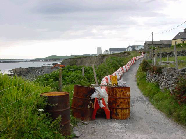 The island's coastline is under threat from erosion. This road has been fenced off to vehicles - pedestrian only at the moment - as the cliff crumbles beneath it. A major job of work is under way to protect roads such as this from the sea.