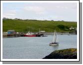 The main pier viewed from across the harbour at Cromwell's Fort. The island has a good few hotels, guesthouses, self-catering accommodation and some excellent restaurants. It is famous for its traditional Irish music in the pubs in the evenings.