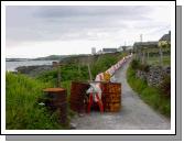 The island's coastline is under threat from erosion. This road has been fenced off to vehicles - pedestrian only at the moment - as the cliff crumbles beneath it. A major job of work is under way to protect roads such as this from the sea.